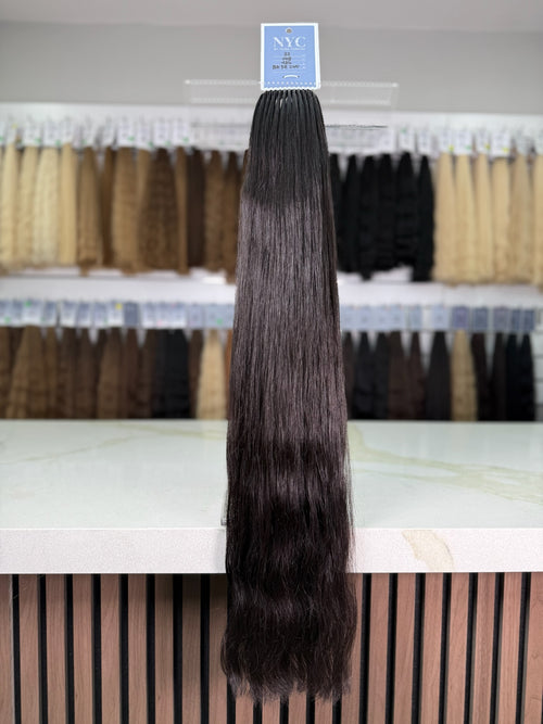 Hair extension displayed in a store with a visible brand label.