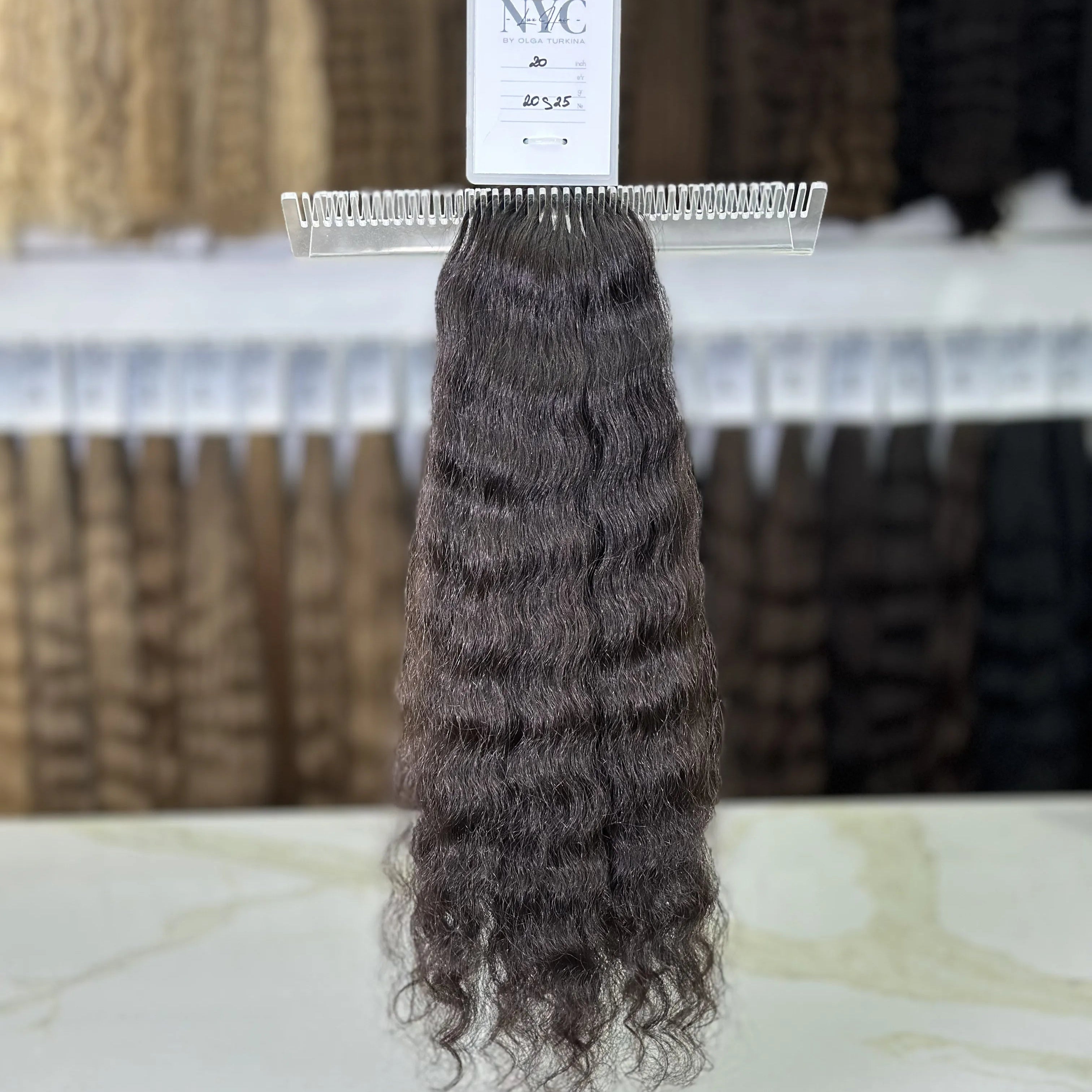 Brown hair extension on a stand with a blurred background
