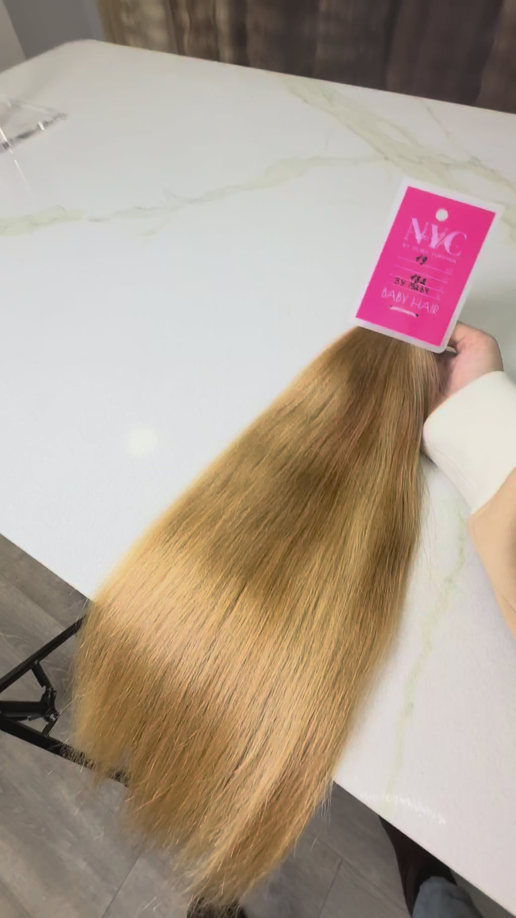 Blonde hair extension on a white surface 