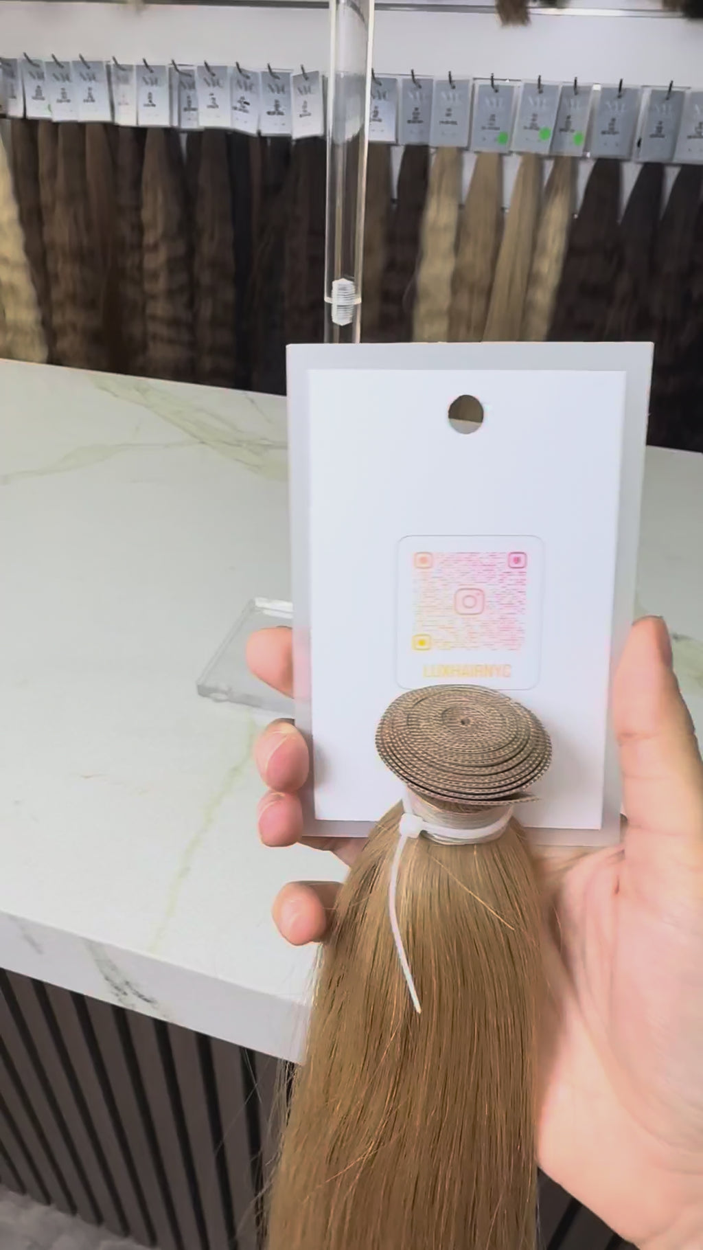 Blonde hair extension on a stand with a blurred background